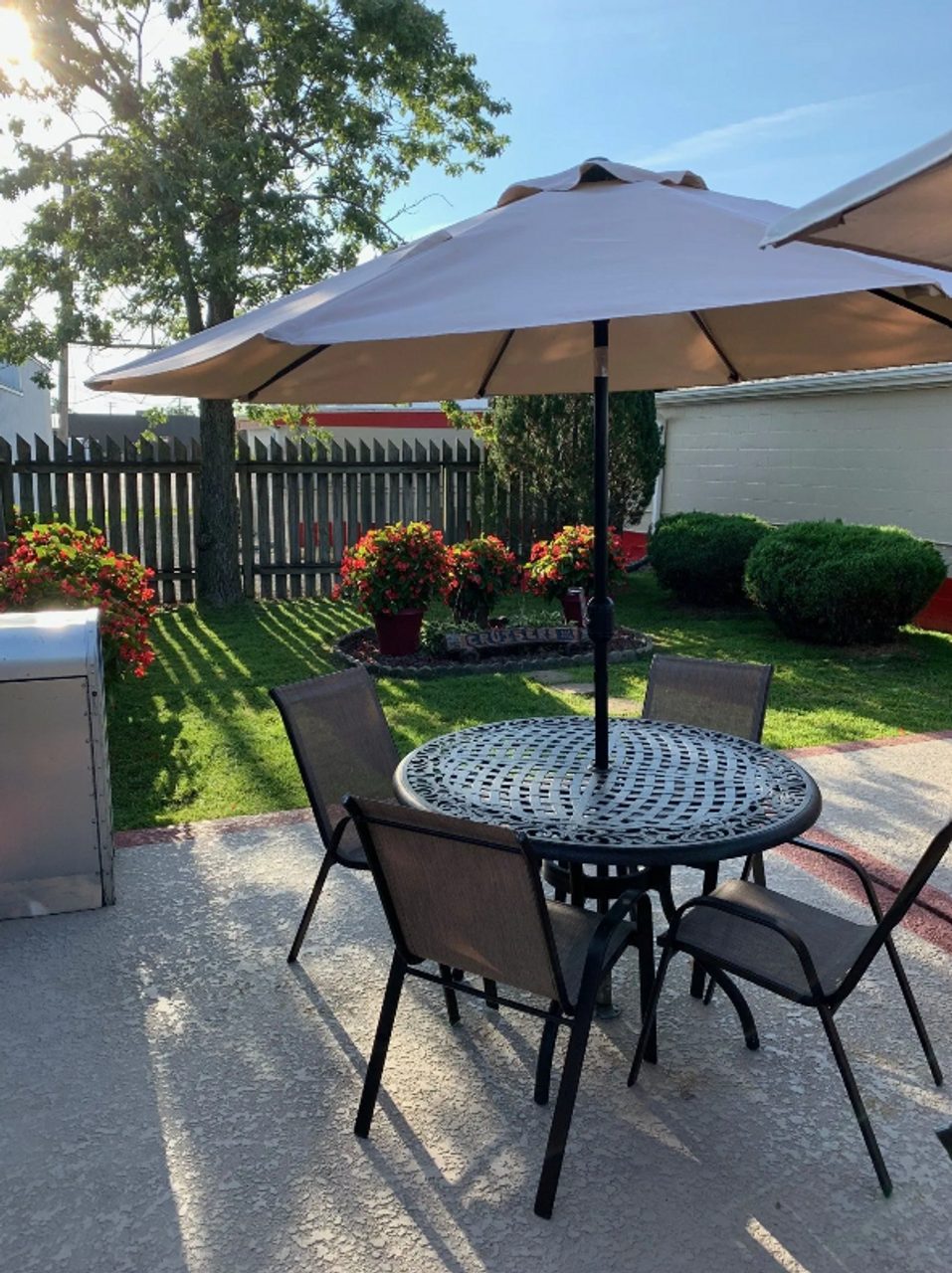 Cruiser's patio table with umbrella and green lawn